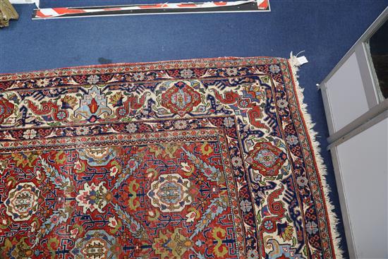 A Persian red ground carpet, 11ft x 7ft 11in.